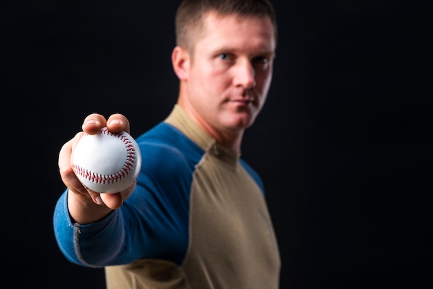 Free photo close-up of baseball held by man