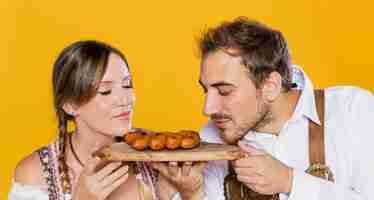 Free photo close-up bavarian friends holding sausages