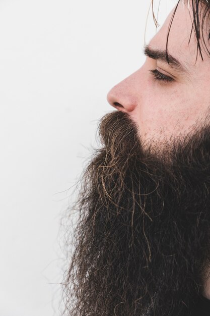 Close-up of a bearded man isolated on white surface