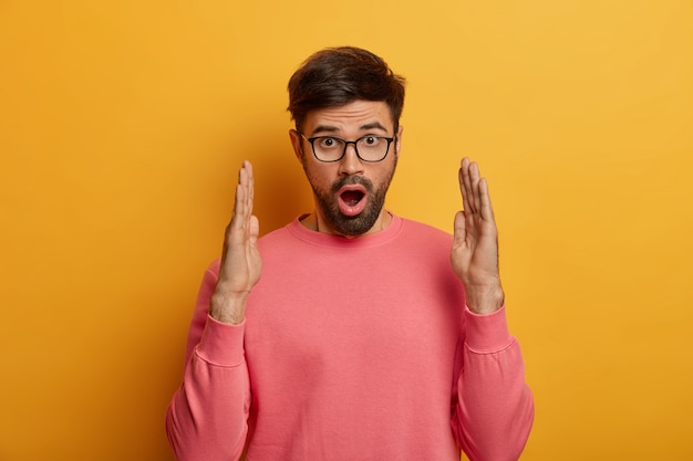 Close up on bearded young man wearing glasses isolated