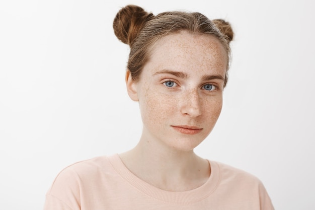 Free photo close-up of beautiful teenage girl posing against the white wall