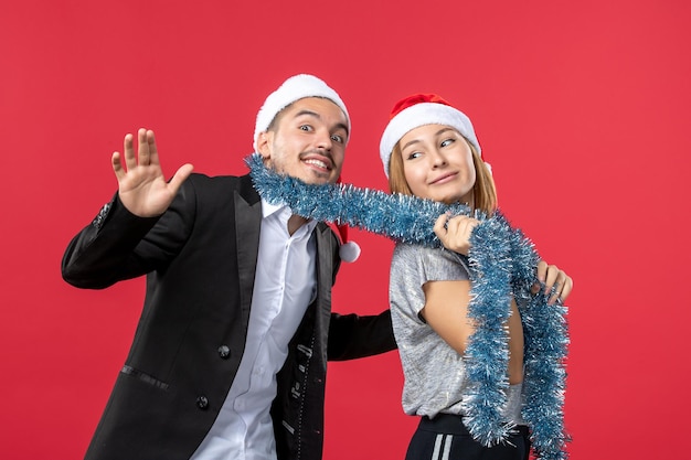 Free photo close up on beautiful young couple wearing santa hats isolated