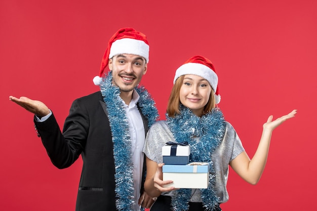 Close up on beautiful young couple wearing Santa hats isolated