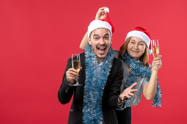 Close up on beautiful young couple wearing Santa hats isolated