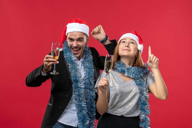 Close up on beautiful young couple wearing Santa hats isolated