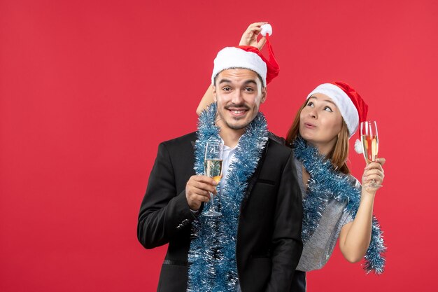 Close up on beautiful young couple wearing Santa hats isolated