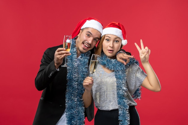 Free Photo close up on beautiful young couple wearing santa hats isolated