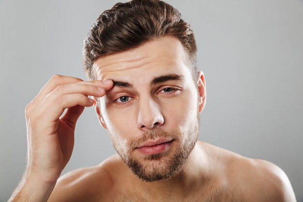 Close up beauty portrait of a young bearded man