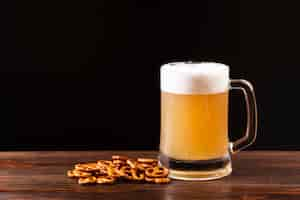 Free photo close-up beer mug with pretzels