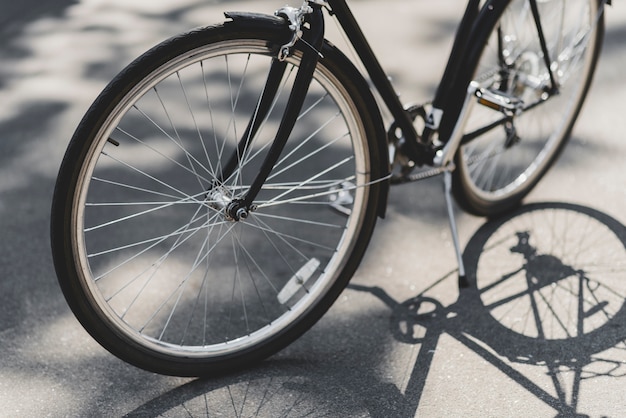 Free photo close-up of bicycle parked on street in sunlight