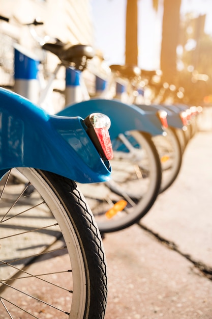 Close-up of bicycles stand in a row on a parking for rent