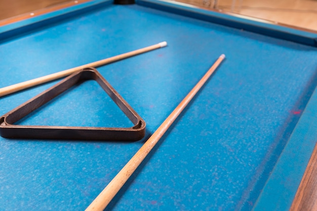 Free photo close-up billiard table with cue sticks