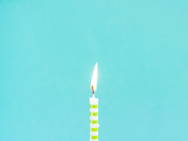 Free photo close-up birthday candle on blue background