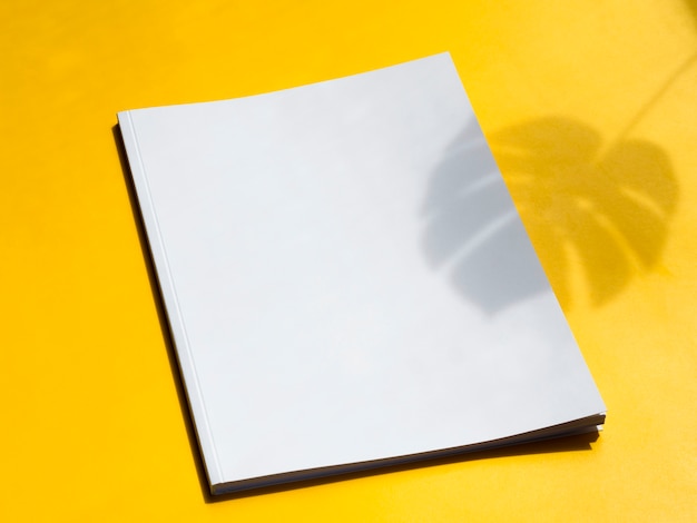 Close-up blank magazine with yellow background