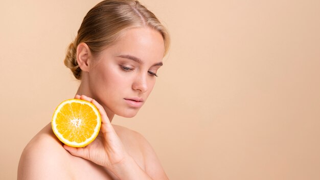 Close-up blonde model with orange posing