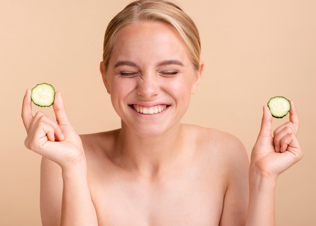 Free Photo close-up blonde woman with cucumber slices