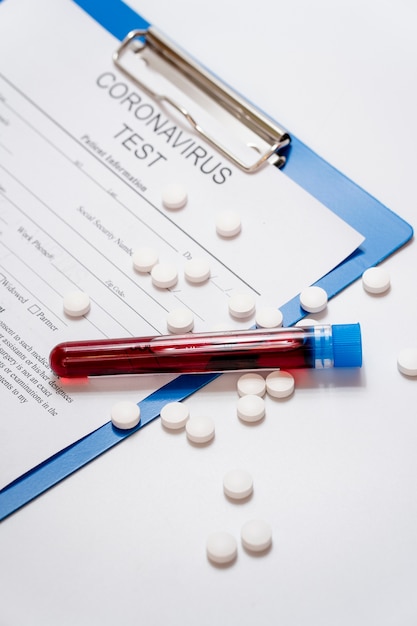 Free photo close-up blood samples with pills and medical form