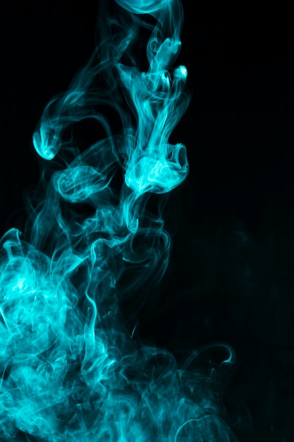 Free photo close-up of blue smoke effect pattern against black backdrop