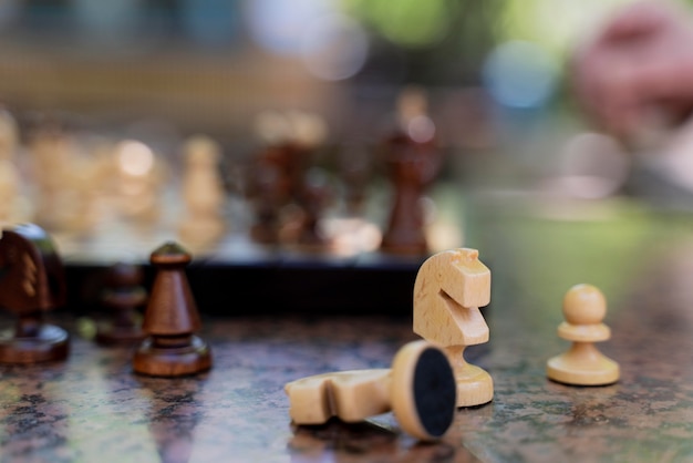 Free Photo close up blurry hand and chess pieces