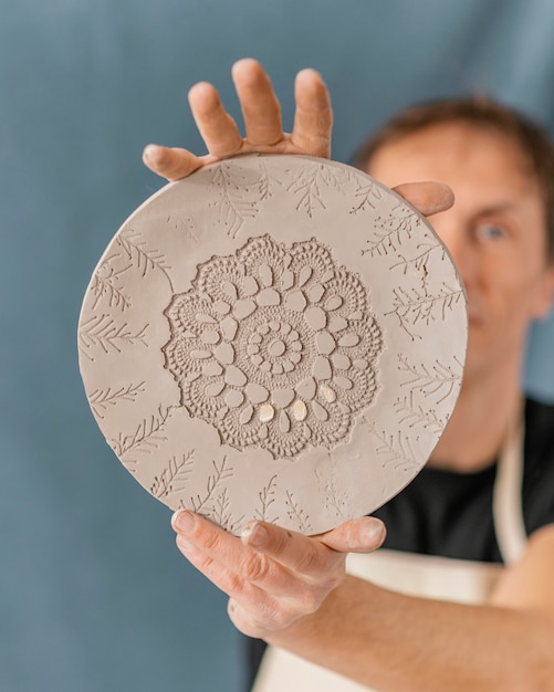 Close-up blurry man holding plate