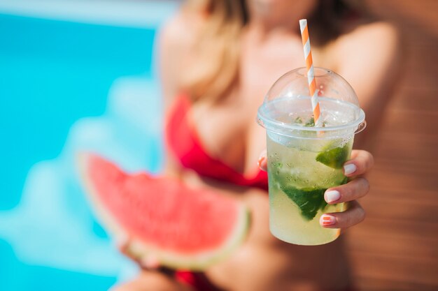 Close-up blurry woman holding a cocktail