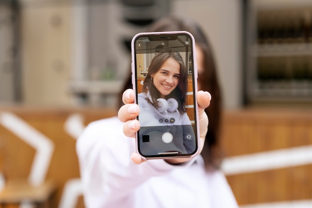 Free photo close up blurry woman holding device