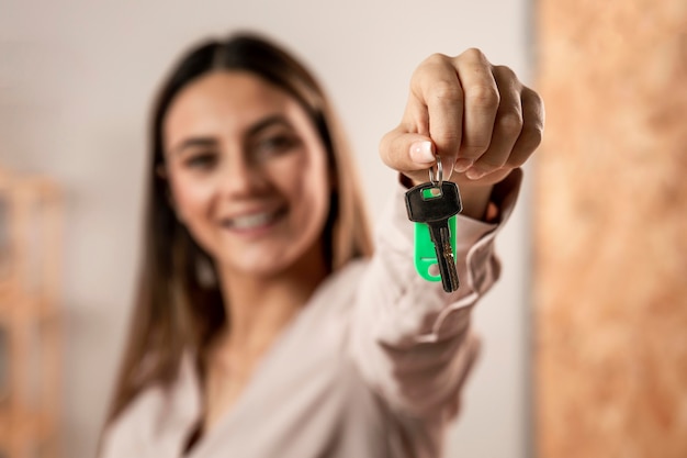 Close-up blurry woman holding keys