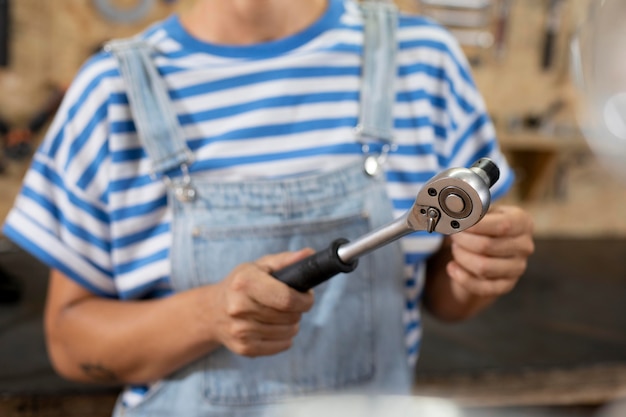 Free Photo close up blurry worker holding tool