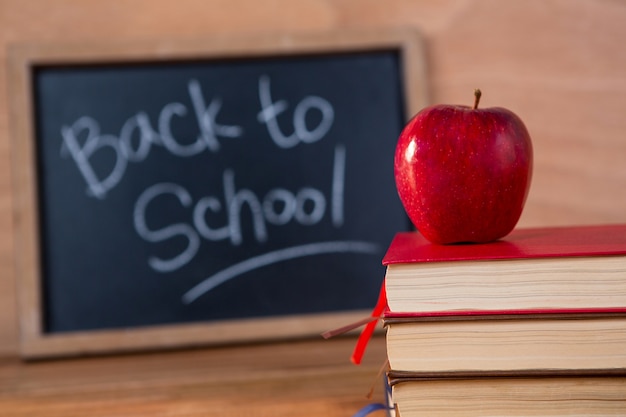 Free photo close-up of books stack with red apple