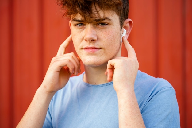 Close-up boy using wireless earphones