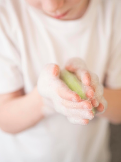 Close-up boy washing hands