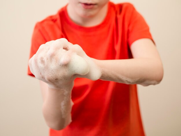 Close-up boy washing his hands