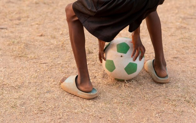 Close up boy with football ball