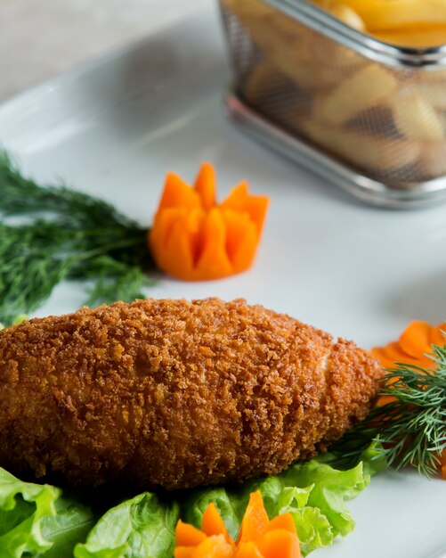 Close up of breaded chicken wrap decorated with carrot flowers