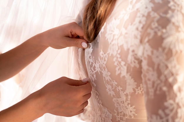 Free Photo close up on bride getting dressed