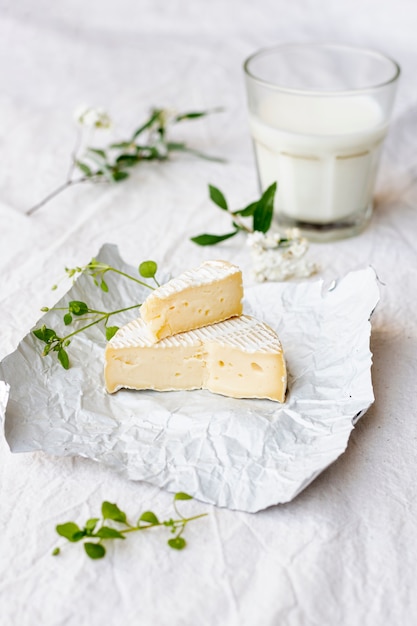 Close-up brie cheese with a glass of milk