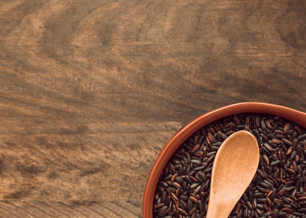 Close-up of brown rice grain in bowls on wooden table