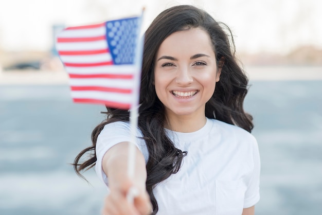 Close-up brunette woman holding usa flag smiling