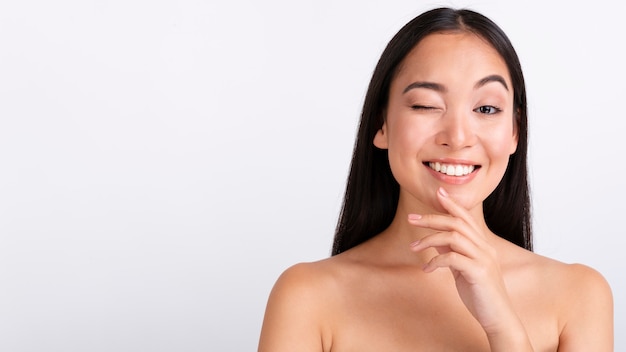 Close-up brunette woman winking 