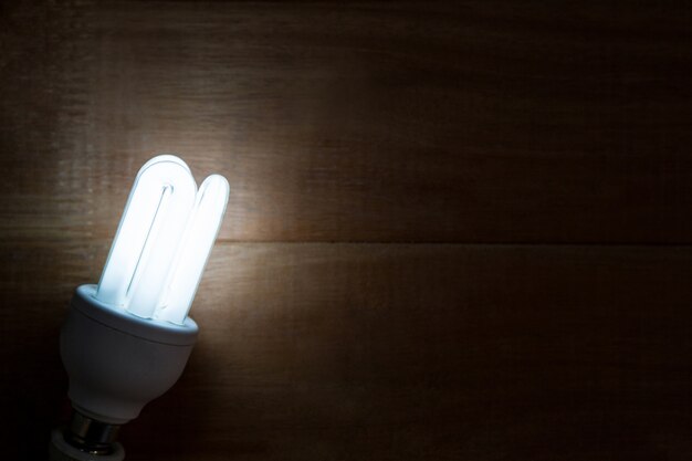 Close-up of bulb glowing on a table