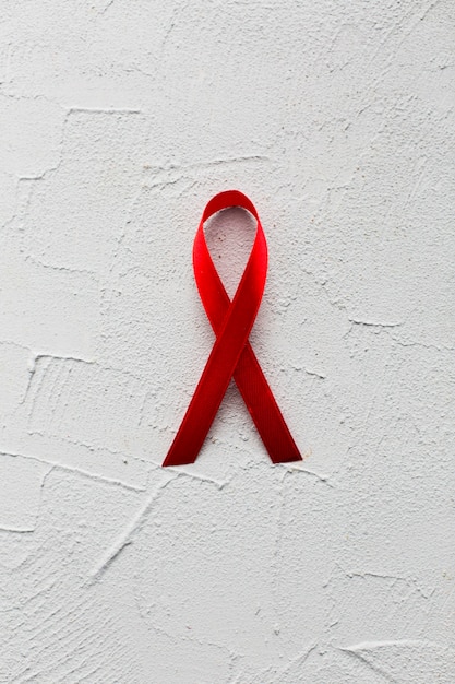 Close-up burgundy ribbon on plaster background