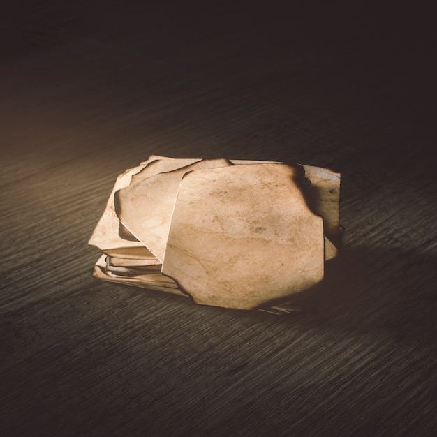 Free Photo close-up burnt paper on wooden tabletop