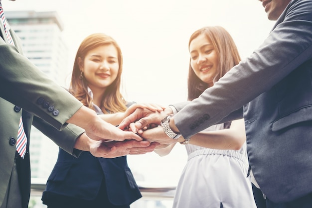 Close up of business people hands together. Teamwork concept.