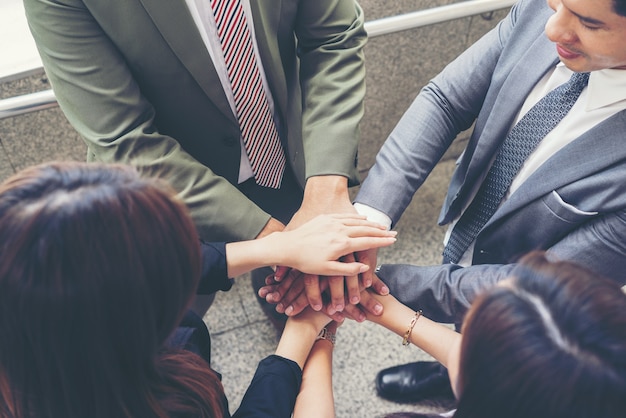 Close up of business people hands together. Teamwork concept.