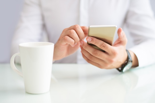 Close-up of businessman browsing internet on phone