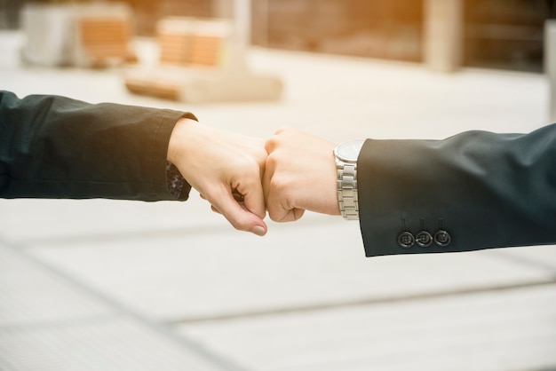 Free photo close-up of businessman and businesswoman making a fist bump