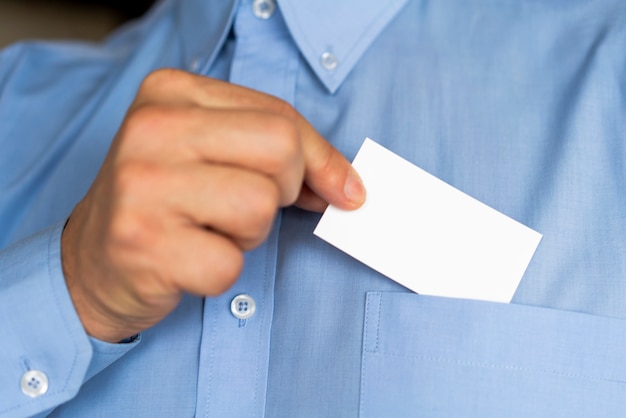 Free Photo close-up businessman holding a card