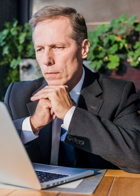 Free photo close-up of a businessman looking at laptop screen