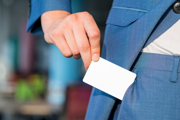 Free Photo close-up of a businessman's hand removing blank white card from pocket