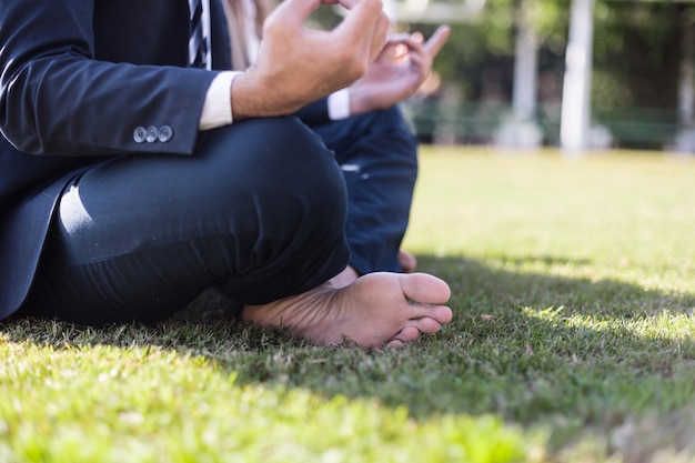 Free photo close-up of businessman sitting cross-legged